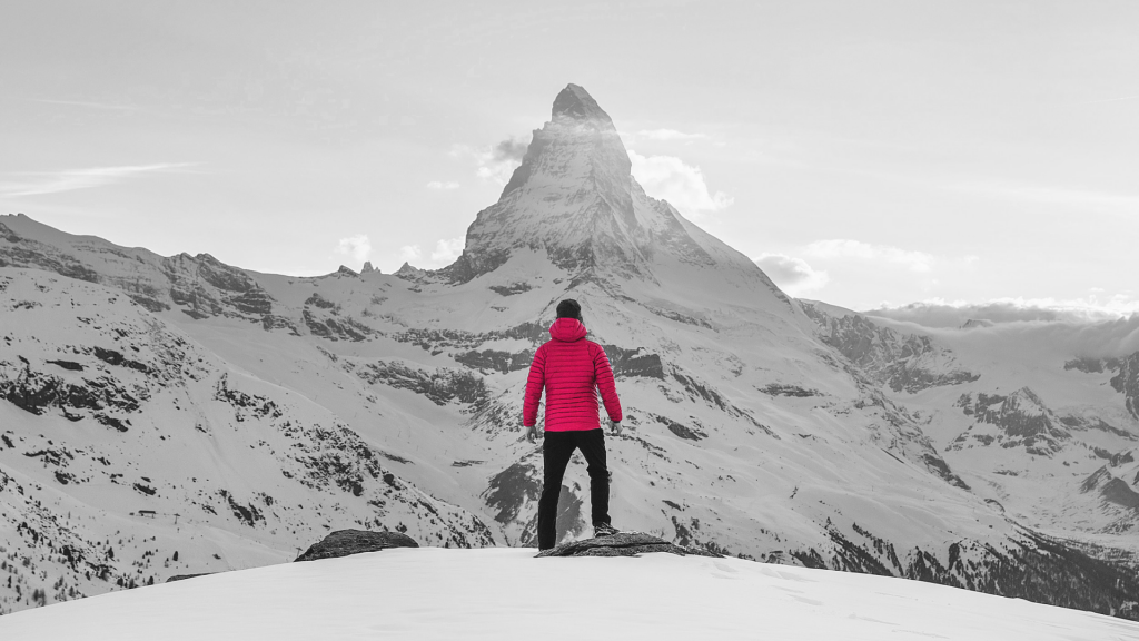 Hiker standing in front of a mountain