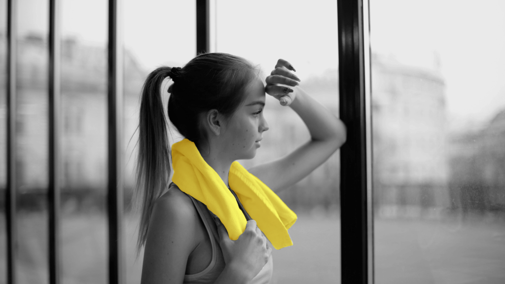 Woman in the gym looking through a window