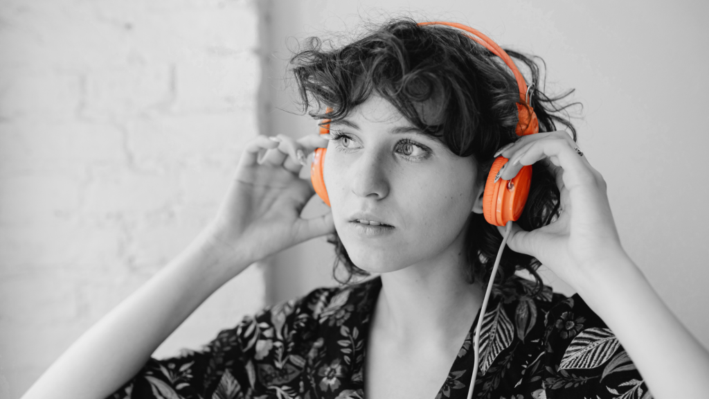 A girl with headphones listening